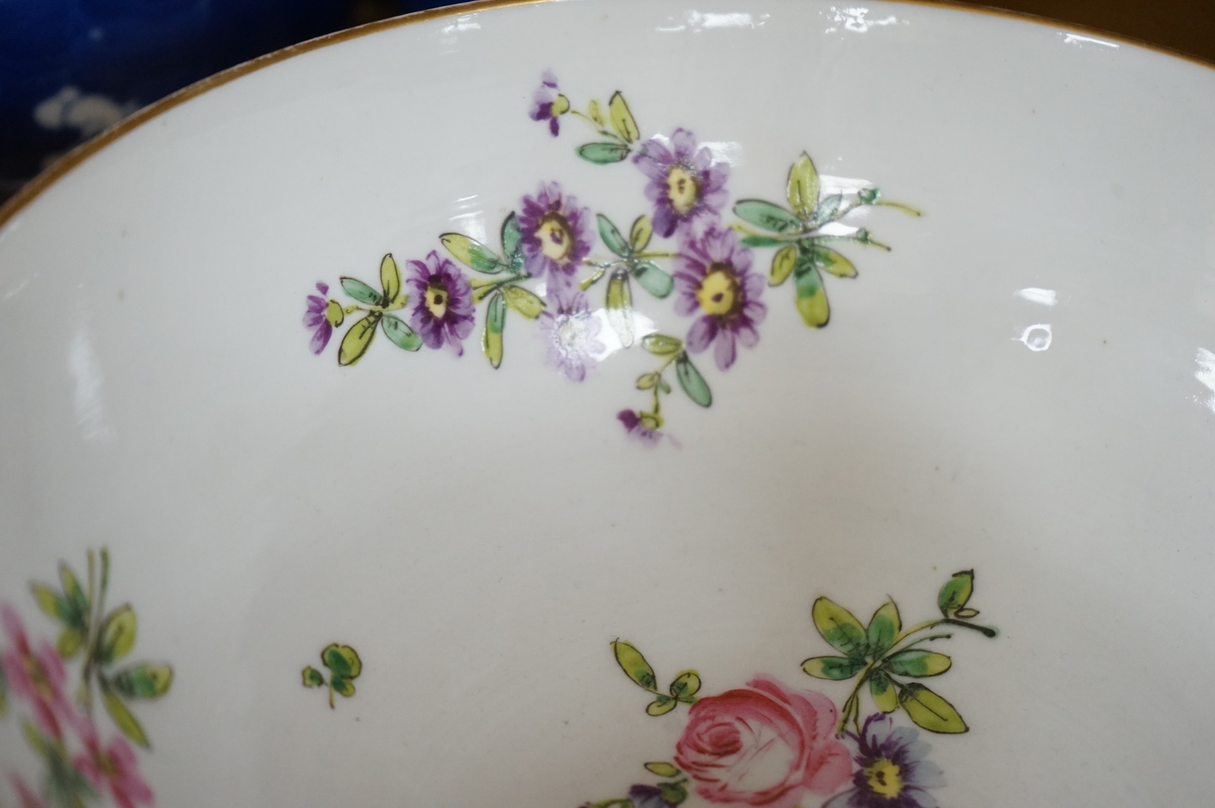 A Continental copy of a Bristol Champions bowl, rose and gilt decorated, 23cm diameter.